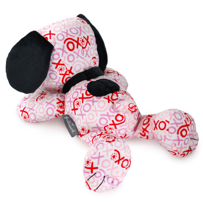 Plush dog toy with pink and red patterns on a white background
