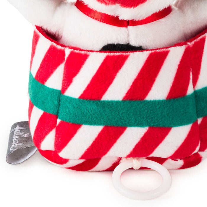 Red and white striped plush toy with a green belt on a white background