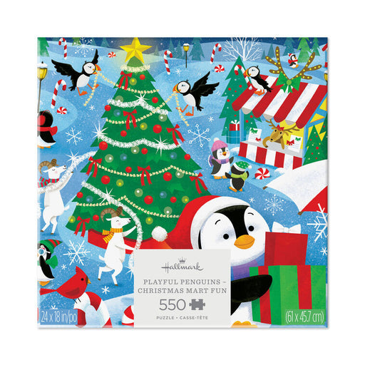 Hallmark 550-piece jigsaw puzzle featuring a festive Christmas penguin scene with penguins, a decorated tree, snow, candy canes, and gift boxes on a blue background.