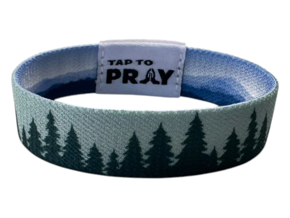 Wristband with tree pattern and 'Tap to Pray' tag on a white background