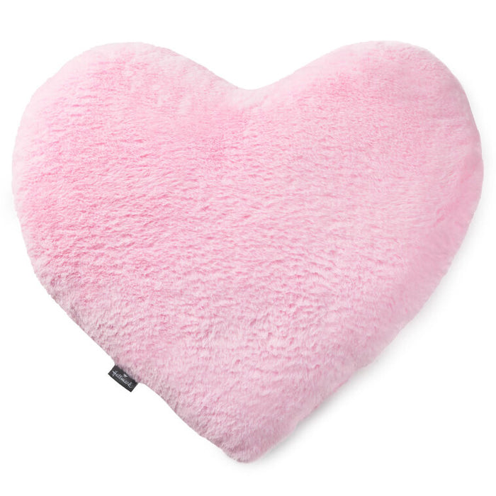 Heart-shaped pink pillow on a white background