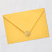 Yellow envelope with a gold wax seal on a light gray background