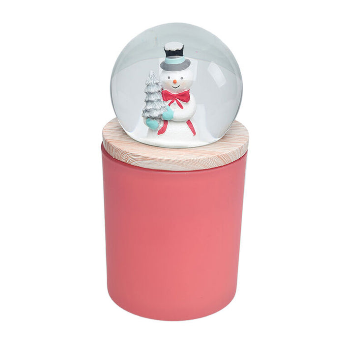 Decorative snow globe with a snowman on a pink base against a white background