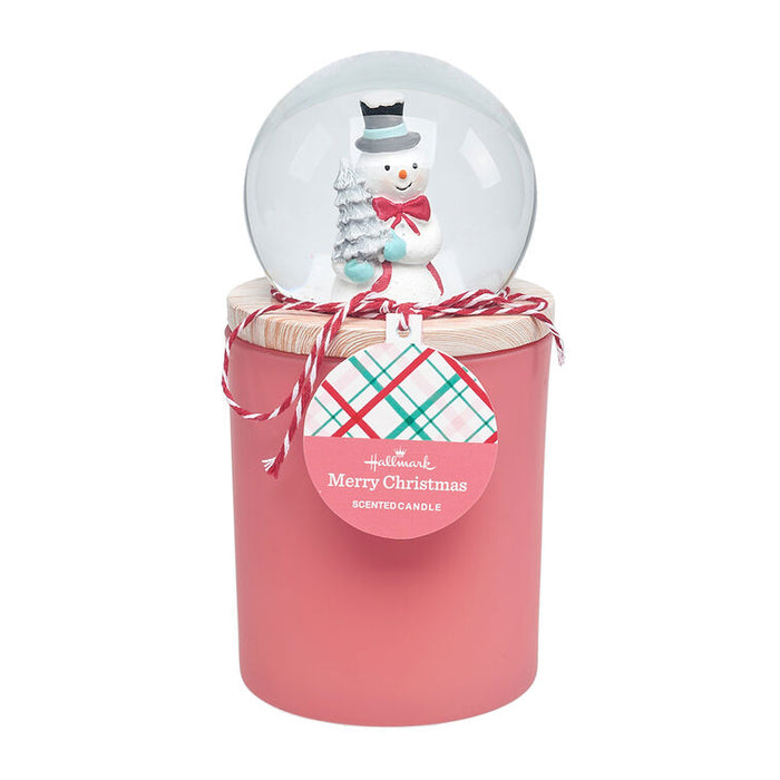 Pink scented candle with a snowman snow globe on top, featuring Hallmark branding.