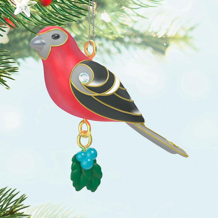 Decorative bird ornament hanging on a Christmas tree