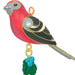 Colorful bird-shaped ornament with a green leaf and blue berries on a white background