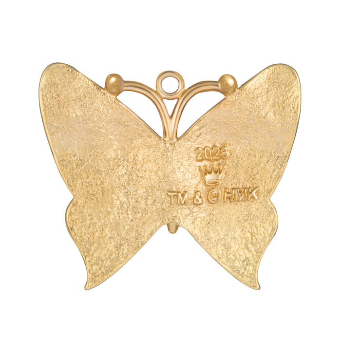 Gold butterfly-shaped pendant with '2023' and 'TV & CHEK' branding on a white background