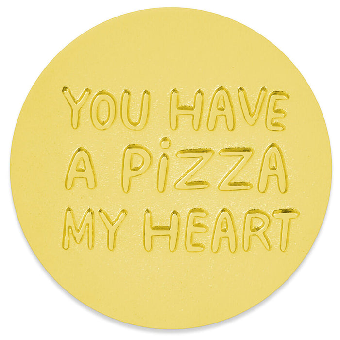 A round gold token with the phrase 'YOU HAVE A PIZZA MY HEART' embossed in raised letters, shown on a plain white background.