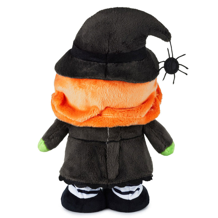 A plush Halloween gnome doll wearing a black pointed hat with a small black spider detail, an orange fuzzy neck, a dark gray robe, and black-and-white striped shoes, shown against a plain white background.