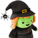 A plush Halloween witch doll with a green face, orange hair, a black hat with a gold buckle, and a black dress, shown on a white background with a small black spider accessory.