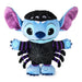 A Stitch plush toy styled as a spider, featuring a light blue body, purple inner ears, a black spiderweb-patterned chest, and purple and black striped arms and legs, set against a plain white background.