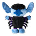 A plush toy character shown from the back, featuring light blue fabric, a black fuzzy head, a blue star-shaped patch on the back, a black body, and purple-striped arms and legs, photographed on a plain white background.