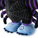 Close-up of a plush monster toy or doll showing the lower body, with a black body printed with a spiderweb pattern, purple striped arms and legs, and light blue feet with dark blue toes. A circular paw-print logo is visible on one foot.