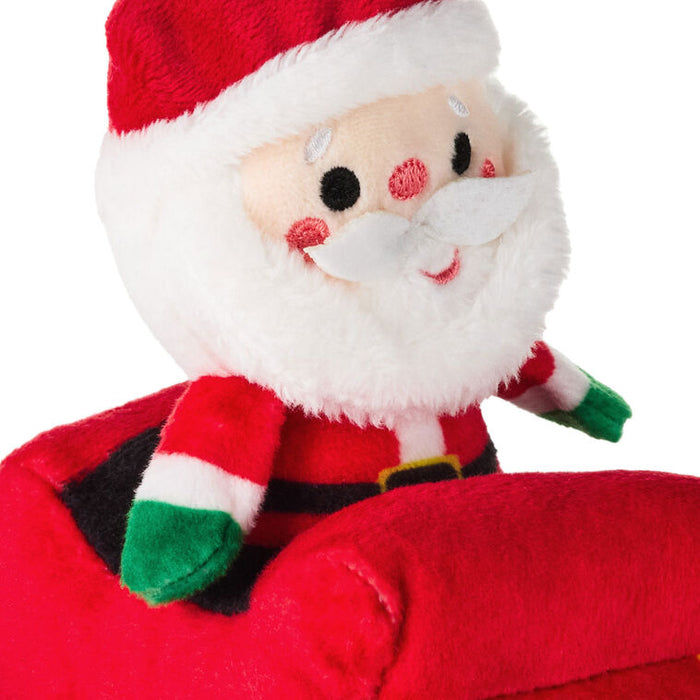 Plush toy resembling Santa Claus on a white background