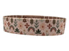 Woven belt with floral and rainbow pattern on a white background