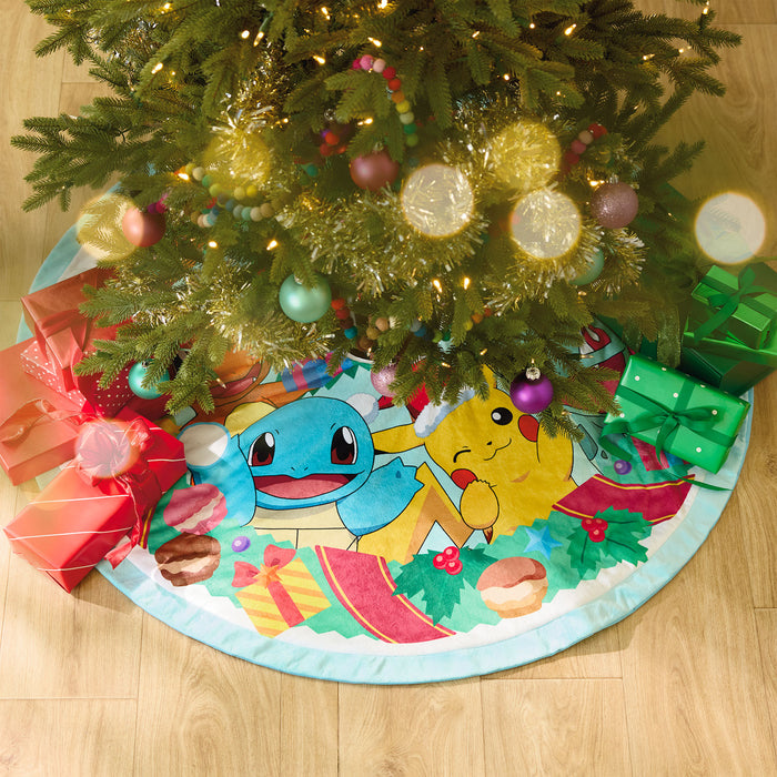 Colorful Christmas tree skirt with cartoon characters under a decorated Christmas tree.