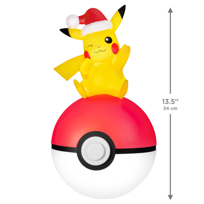 Pikachu on a Poké Ball with a Santa hat, showing dimensions on a white background