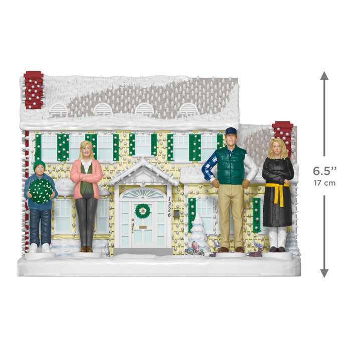 Model of a house with decorative elements and people on a white background