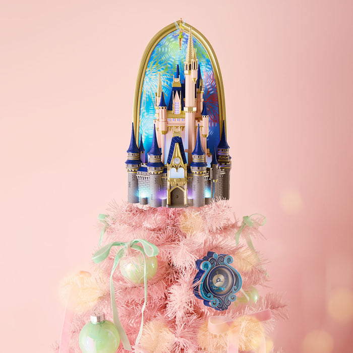 Decorative castle on a pink tree with ornaments against a light pink background
