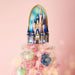 Decorative castle on a pink tree with ornaments against a light pink background