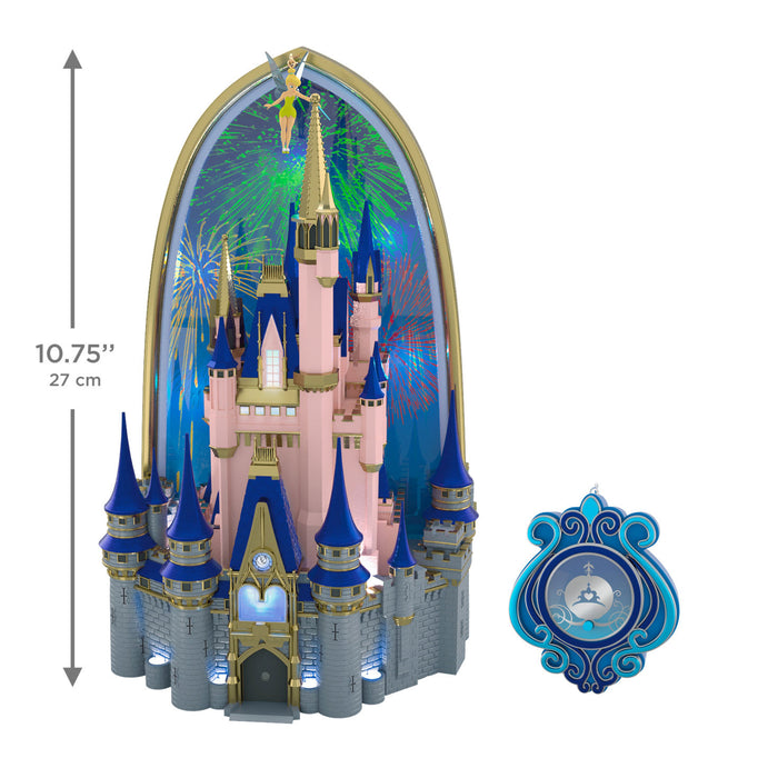 Disney castle model with blue spires and gold accents, featuring fireworks in the background.