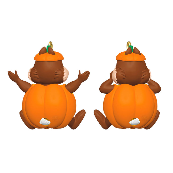 Two pumpkin-shaped figurines with brown faces and orange hats on a white background
