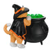 Cat figurine dressed as a witch with a black cauldron and green beads on a white background