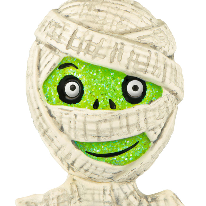 Mummy figurine with green face and white bandages on a white background