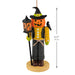 Halloween-themed ornament with a pumpkin face, lantern, and black hat on a white background.