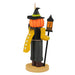 Halloween-themed ornament with a pumpkin head, black hat, yellow coat, and lantern on a white background.