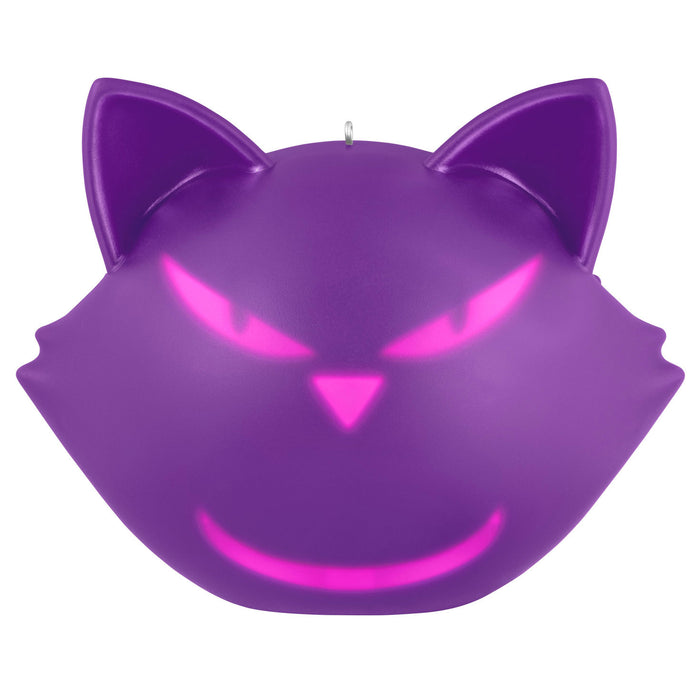 Purple cat-shaped candle with glowing pink eyes on a white background