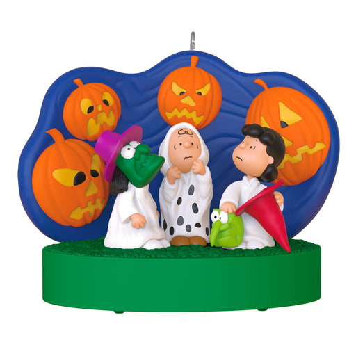 Halloween-themed ornament with characters and pumpkins on a white background
