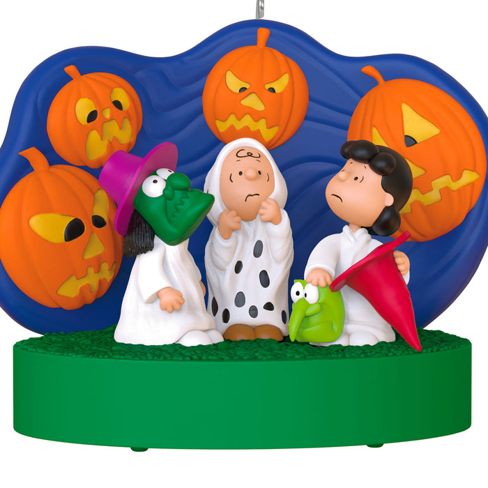 Decorative ornament featuring characters from 'Peanuts' with Halloween-themed pumpkins.