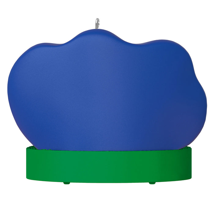 Blue cloud-shaped object on a green base with a white background