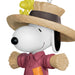 Snoopy figurine in a pink shirt and straw hat with a small dog on his shoulder, on a white background