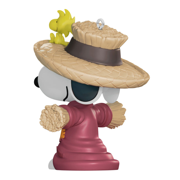 Figurine of a character wearing a straw hat with a smaller figure on top, on a white background
