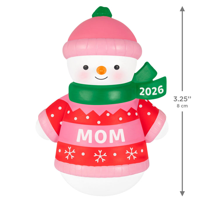 Inflatable snowman figurine with a red 'MOM' sweater, pink hat, and green scarf on a white background.