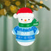 Christmas ornament of a snowman wearing a blue sweater with 'DAD' and a red hat, hanging on a tree.