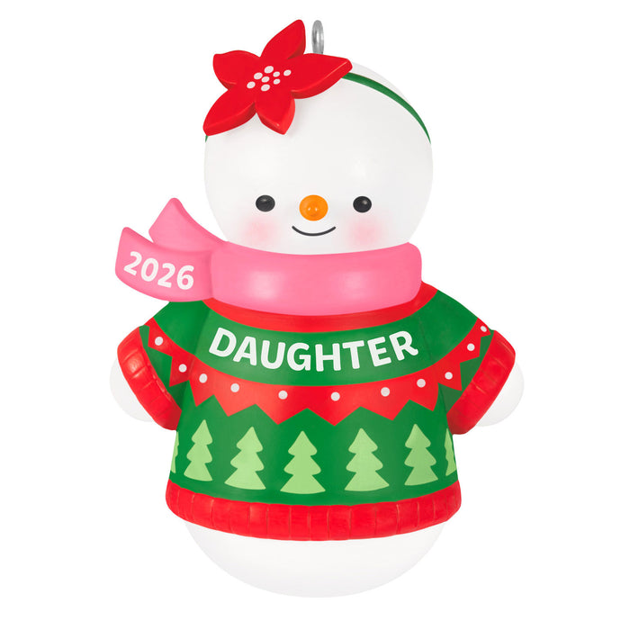 Christmas ornament of a snowman wearing a green sweater with 'DAUGHTER' text and a red flower hat on a white background.