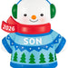 Snowman ornament with 2026 scarf, blue sweater with green trees, and green headphones on a white background.