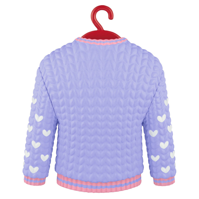 Light purple quilted sweater with heart patterns on a hanger against a white background