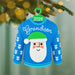 Blue sweater ornament with Santa face and 'Grandson' text, hanging on a Christmas tree.