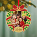 Personalized Christmas ornament with a family photo and '2026' on a decorated tree.