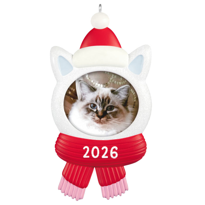 Cat-shaped Christmas ornament with a picture of a cat, red scarf, and Santa hat on a white background.