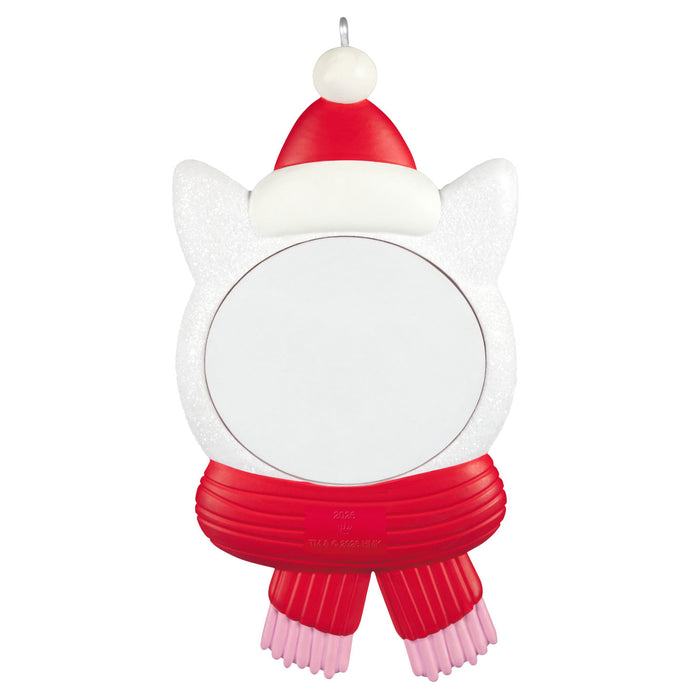Cat-shaped ornament with a Santa hat and red scarf on a white background
