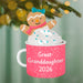 Christmas ornament of a gingerbread girl in a mug with 'Great-Granddaughter 2026' text, hanging on a tree.