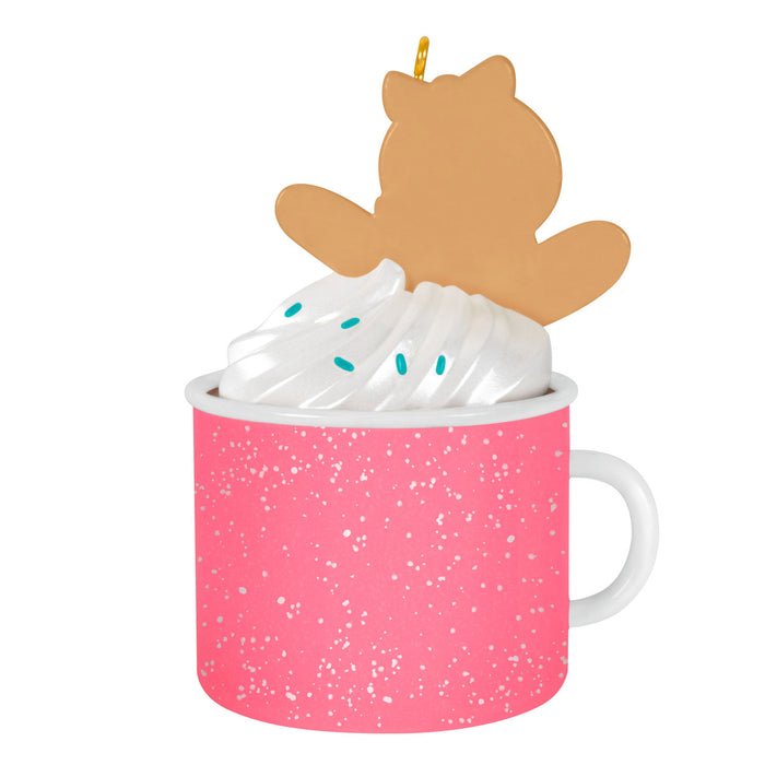 Pink mug with whipped cream and a gingerbread on a white background