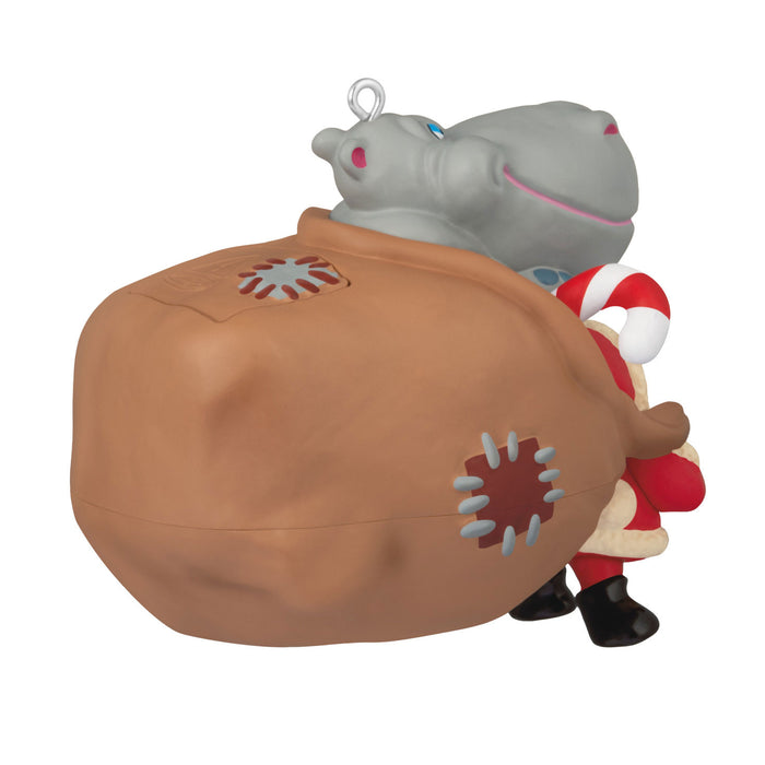 Decorative ornament with a hippo in a bag and Santa Claus on a white background