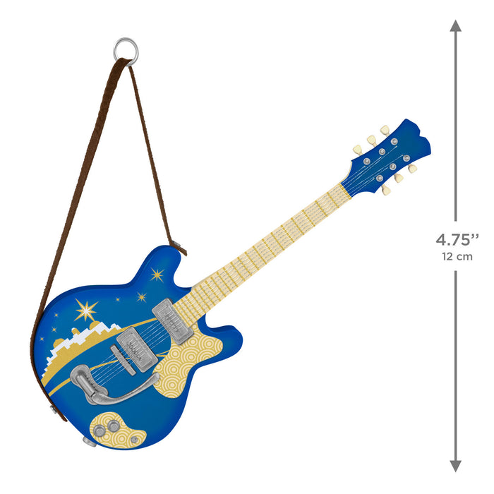 Blue electric guitar-shaped ornament with a brown strap on a white background
