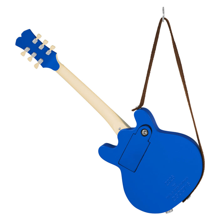 Blue electric guitar ornament with a strap on a white background